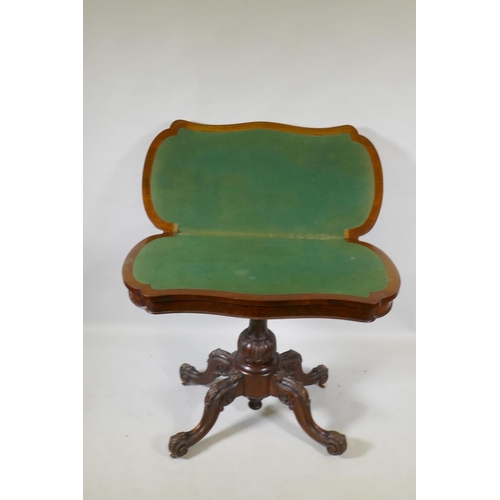 1070 - A Victorian burr walnut shaped top card table, raised on a carved and turned column and cabriole sup... 