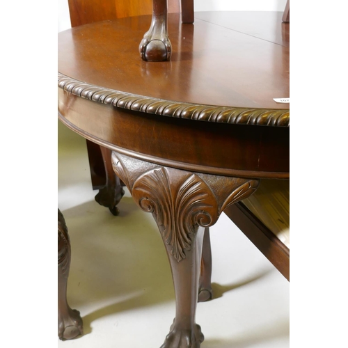 1071 - A C19th Chippendale style mahogany wind-out dining table with gadrooned edge and two leaves, raised ... 