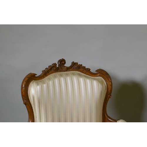 1073 - A pair of C19th French carved beechwood open armchairs with shaped backs, raised on cabriole support... 