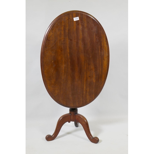 1075 - A Victorian mahogany tilt top occasional table, raised on turned column and tripod supports, 54 x 75... 