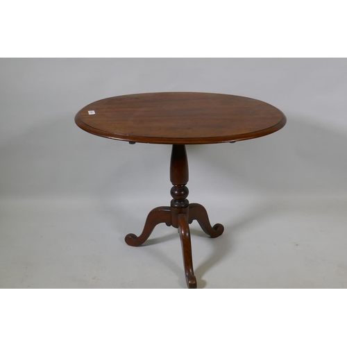 1075 - A Victorian mahogany tilt top occasional table, raised on turned column and tripod supports, 54 x 75... 