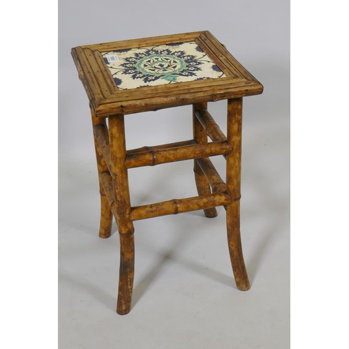 1081 - An antique Oriental bamboo occasional table inset with an Iznik tile top, 30 x 30cm, 47cm high