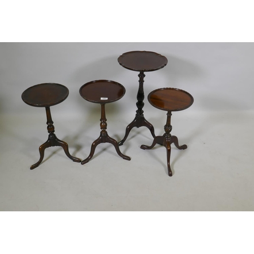 1083 - A pair of mahogany wine tables with dished tops, raised on turned columns with tripod supports, 27cm... 