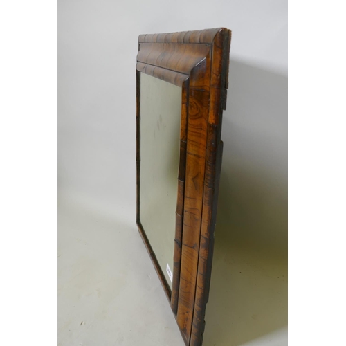 1085 - A William and Mary well figured walnut veneered cushion mirror with antique glass, 59 x 50cm