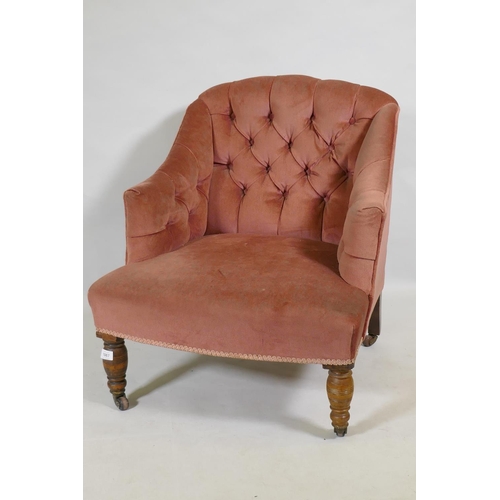 1087 - A Victorian button back nursing chair, raised on turned supports