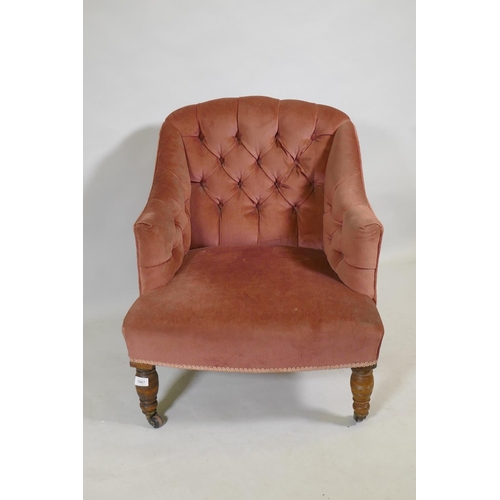 1087 - A Victorian button back nursing chair, raised on turned supports