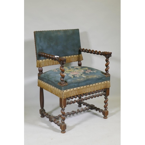 1091 - A Jacobean style walnut open armchair with barley twist and carved lion decoration, studded tapestry... 