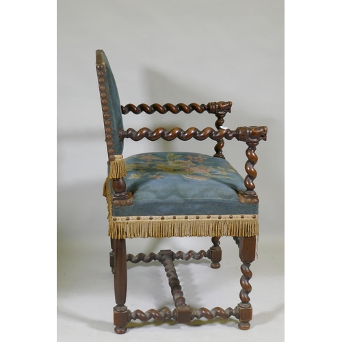 1091 - A Jacobean style walnut open armchair with barley twist and carved lion decoration, studded tapestry... 