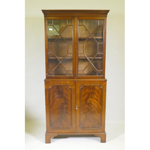 1096 - A small Georgian style mahogany bookcase in two sections, the upper with astragal glazed doors, the ... 