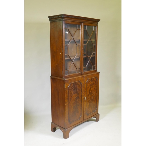 1096 - A small Georgian style mahogany bookcase in two sections, the upper with astragal glazed doors, the ... 