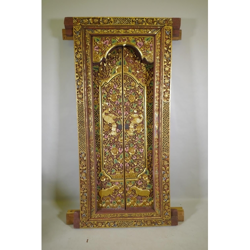 1097 - Architectural Salvage, an Oriental carved, painted and parcel gilt set of doors and frame, with phoe... 