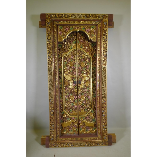 1097 - Architectural Salvage, an Oriental carved, painted and parcel gilt set of doors and frame, with phoe... 