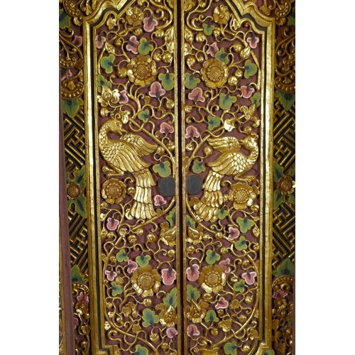 1097 - Architectural Salvage, an Oriental carved, painted and parcel gilt set of doors and frame, with phoe... 