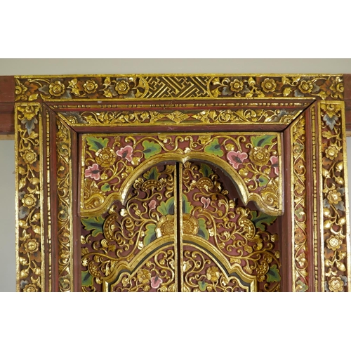 1097 - Architectural Salvage, an Oriental carved, painted and parcel gilt set of doors and frame, with phoe... 