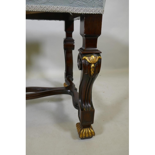 1098 - A mahogany stool with carved and parcel gilt decoration, raised on shaped and scrolled supports unit... 