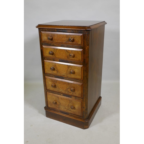 1099 - A Victorian figured walnut chest with canted corners and five graduated drawers, raised on a plinth ... 