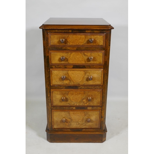 1099 - A Victorian figured walnut chest with canted corners and five graduated drawers, raised on a plinth ... 