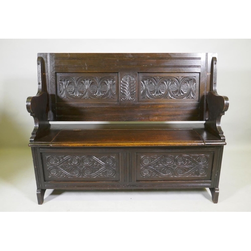 1103 - A Victorian oak monk's bench, with two panel fold over top, lift up seat and panelled front with car... 