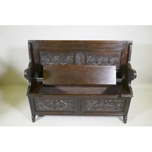 1103 - A Victorian oak monk's bench, with two panel fold over top, lift up seat and panelled front with car... 