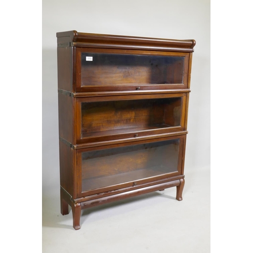 1110 - A mahogany Globe Wernicke style three section bookcase, raised on a base with shaped supports, 87 x ... 