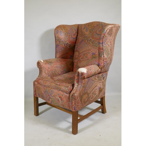 1116 - A Georgian style wingback armchair