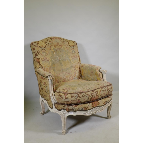 1117 - An C18th style French carved and painted beechwood framed arm chair with tapestry covers