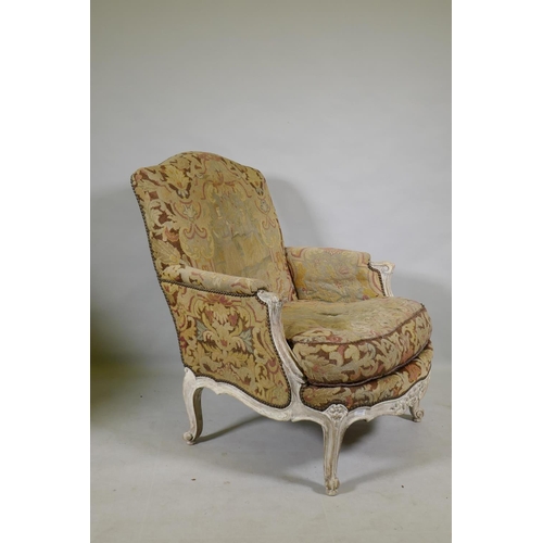 1117 - An C18th style French carved and painted beechwood framed arm chair with tapestry covers