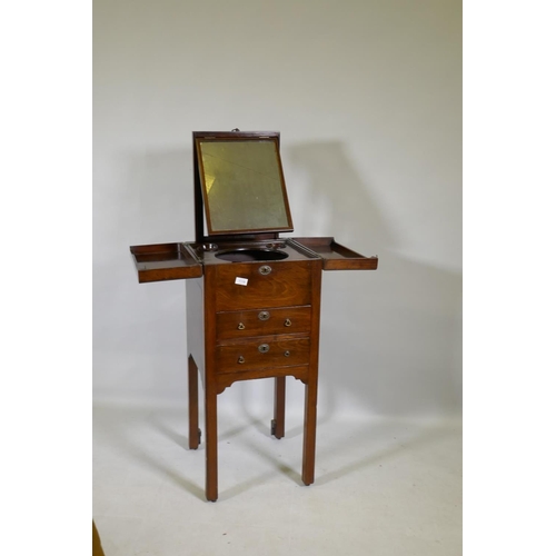 1119 - A Georgian mahogany gentleman's washstand, the fold out top with fitted interior and turned wood bow... 