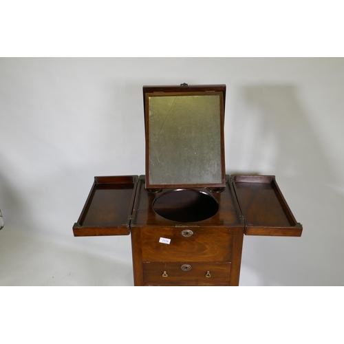 1119 - A Georgian mahogany gentleman's washstand, the fold out top with fitted interior and turned wood bow... 