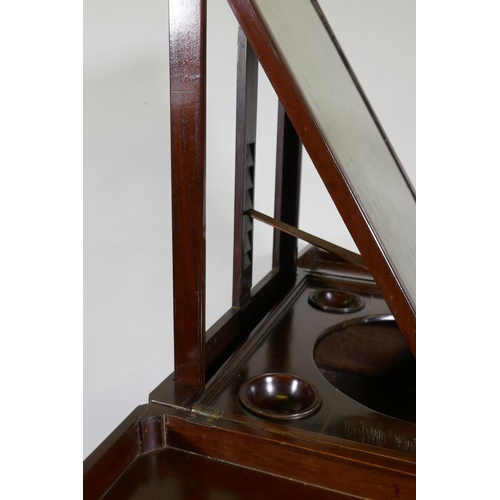 1119 - A Georgian mahogany gentleman's washstand, the fold out top with fitted interior and turned wood bow... 