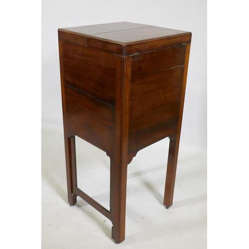 1119 - A Georgian mahogany gentleman's washstand, the fold out top with fitted interior and turned wood bow... 