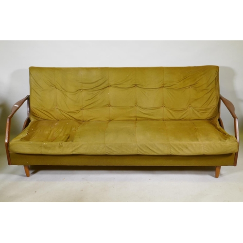 1120 - A mid century teak sofa bed in the manner of Greaves & Thomas, structurally sound, upholstery AF... 