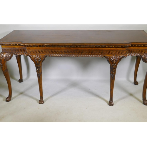 1123 - A pair of Georgian style mahogany breakfront serving tables, with key pattern frieze and carved cabr... 