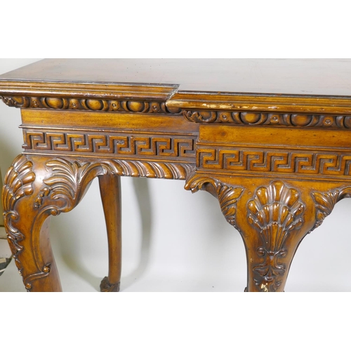 1123 - A pair of Georgian style mahogany breakfront serving tables, with key pattern frieze and carved cabr... 