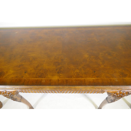 1123 - A pair of Georgian style mahogany breakfront serving tables, with key pattern frieze and carved cabr... 