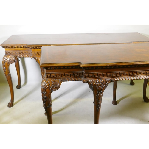 1123 - A pair of Georgian style mahogany breakfront serving tables, with key pattern frieze and carved cabr... 