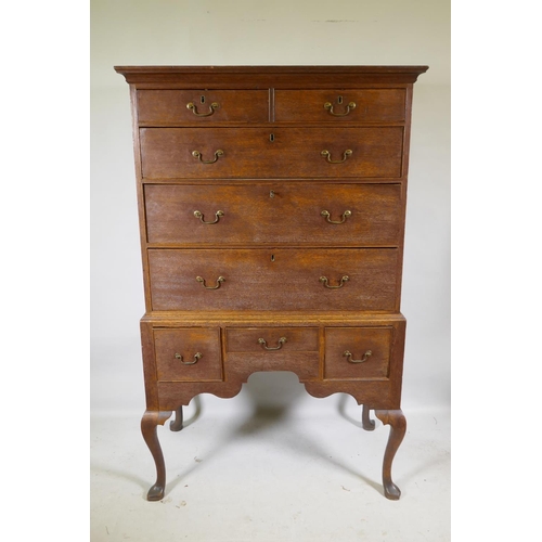 1124 - A Georgian oak chest on stand, the upper section with two over three drawers, the base with three dr... 