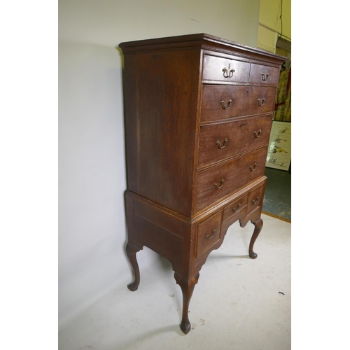 1124 - A Georgian oak chest on stand, the upper section with two over three drawers, the base with three dr... 