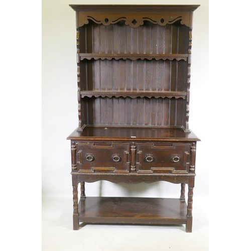 1125 - A late C19th oak potboard dresser with enclosed rack and pierced frieze, the base with two drawers a... 