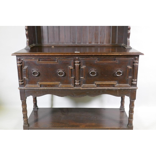 1125 - A late C19th oak potboard dresser with enclosed rack and pierced frieze, the base with two drawers a... 