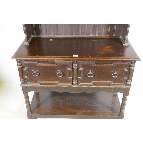 1125 - A late C19th oak potboard dresser with enclosed rack and pierced frieze, the base with two drawers a... 