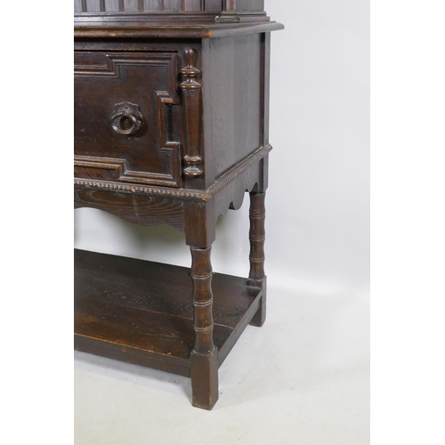 1125 - A late C19th oak potboard dresser with enclosed rack and pierced frieze, the base with two drawers a... 