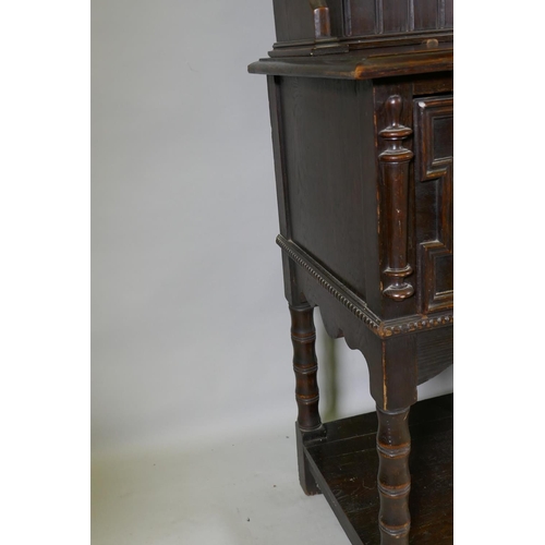 1125 - A late C19th oak potboard dresser with enclosed rack and pierced frieze, the base with two drawers a... 