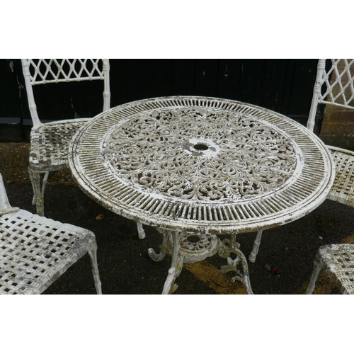 1129 - A painted metal garden table and four chairs with faux bamboo decoration and trellis backs, 80cm dia... 