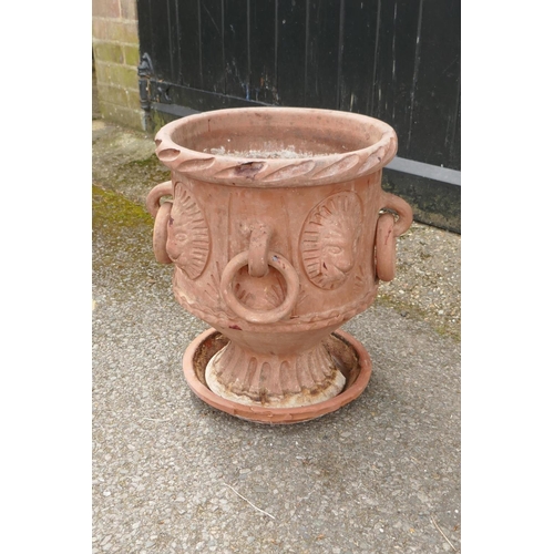 1131 - A C19th terracotta urn with four loop handles and lion mask decoration, 41cm high, 34cm diameter