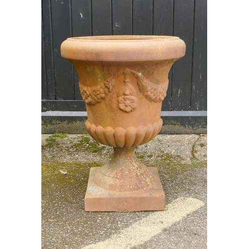 1134 - A terracotta garden urn, with floral swag decoration, 67cm high x 48cm diameter