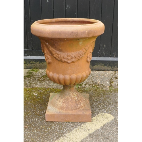 1134 - A terracotta garden urn, with floral swag decoration, 67cm high x 48cm diameter