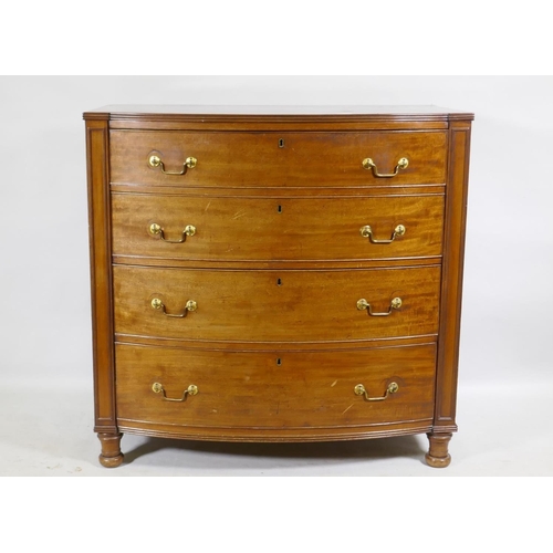 1145 - A C19th mahogany bow front chest of four long drawers, flanked by moulded panels and raised on turne... 