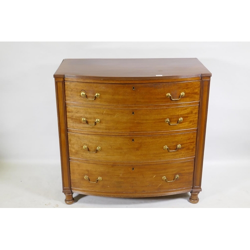 1145 - A C19th mahogany bow front chest of four long drawers, flanked by moulded panels and raised on turne... 