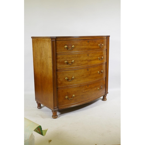 1145 - A C19th mahogany bow front chest of four long drawers, flanked by moulded panels and raised on turne... 